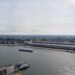 Birds eye view of the IJ river with the city of Amsterdam and Amsterdam Central Station in the background